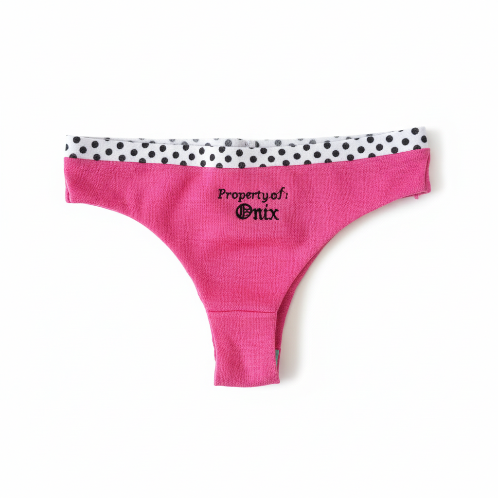 Flat lay of hot pink personalized embroidered underwear with polka dot waistband