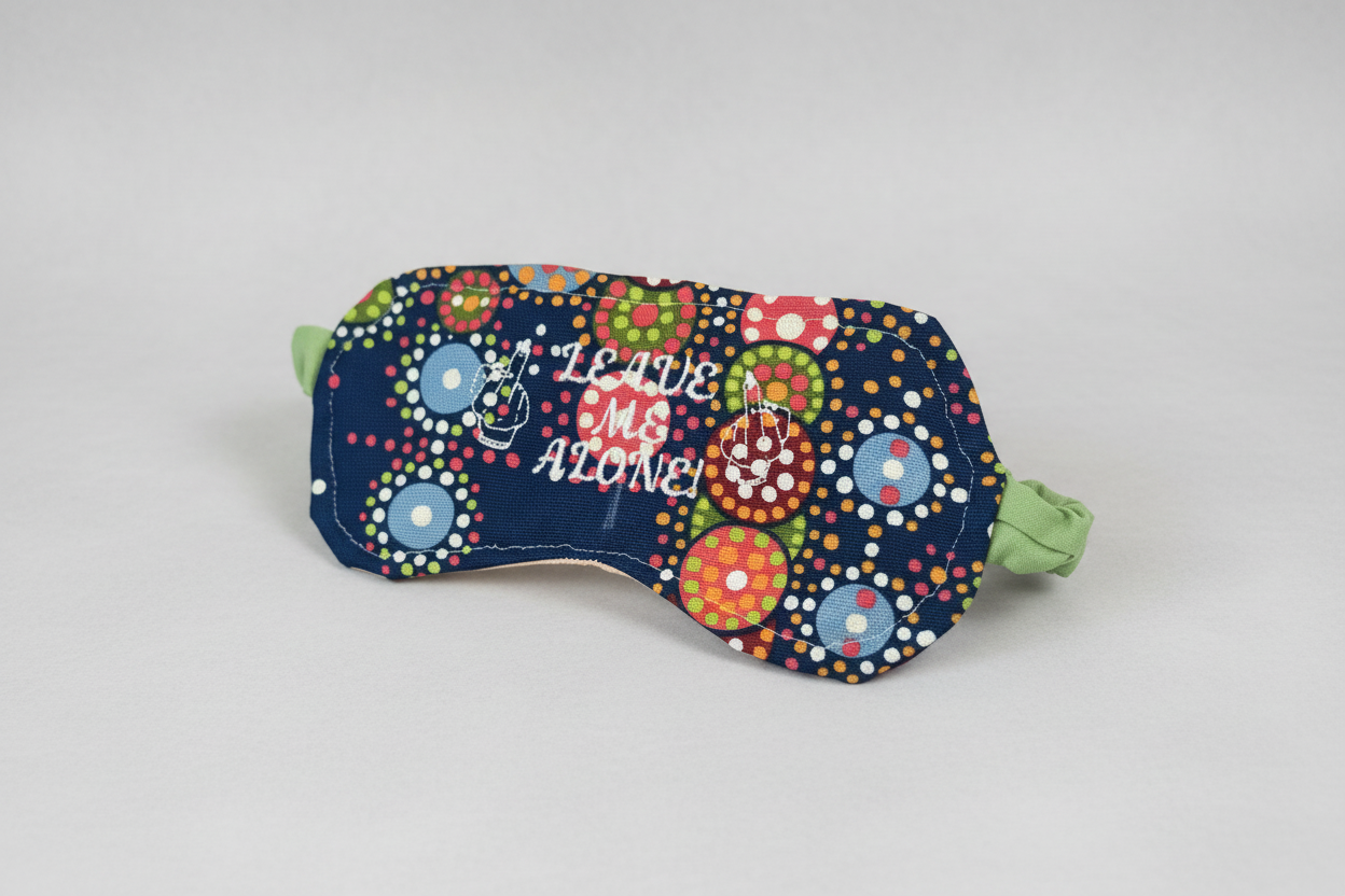 Handmade embroidered sleep mask with colorful polka dot fabric and Leave Me Alone embroidery